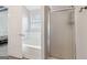 Bright bathroom with a white bathtub, glass shower, and a doorway leading into a bedroom at 1152 Sunday Ln, Jonesboro, GA 30238
