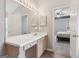 Bright bathroom with a large mirror, vanity, and doorway providing a glimpse into the adjacent bedroom at 1152 Sunday Ln, Jonesboro, GA 30238