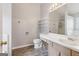 Bright bathroom with storage shelves, a clean vanity, and a large mirror at 1152 Sunday Ln, Jonesboro, GA 30238