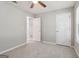 Bright, carpeted bedroom with a ceiling fan and two doors at 1152 Sunday Ln, Jonesboro, GA 30238