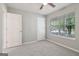 Clean bedroom with a large window offering pleasant outdoor views and two entry doors at 1152 Sunday Ln, Jonesboro, GA 30238