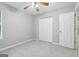 Well-lit bedroom with neutral walls, a ceiling fan, carpeted floor, and double door closet at 1152 Sunday Ln, Jonesboro, GA 30238