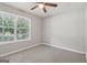 Well-lit bedroom featuring a ceiling fan and a large window offering outdoor views at 1152 Sunday Ln, Jonesboro, GA 30238