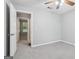 Clean bedroom with neutral colored walls, a ceiling fan, and a door that leads to another room at 1152 Sunday Ln, Jonesboro, GA 30238