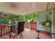 Cozy covered deck with outdoor dining set, plants, and access to the backyard at 1152 Sunday Ln, Jonesboro, GA 30238