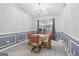 Inviting dining area with table, seating, stylish wainscoting, and chandelier at 1152 Sunday Ln, Jonesboro, GA 30238