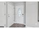 Clean entryway with hardwood floors, white trim, and door with ornate oval window to let in light at 1152 Sunday Ln, Jonesboro, GA 30238