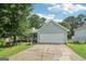 Light blue single-story home featuring a two-car garage, lovely porch, manicured lawn and mature trees at 1152 Sunday Ln, Jonesboro, GA 30238