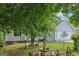 Beautiful landscaping surrounds this light blue home, complete with mature trees and a large two car garage at 1152 Sunday Ln, Jonesboro, GA 30238
