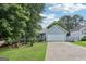 Charming, light blue single-story home featuring a two-car garage, manicured lawn and lush trees at 1152 Sunday Ln, Jonesboro, GA 30238