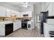 Updated kitchen with white cabinets, black appliances, and stylish backsplash at 1152 Sunday Ln, Jonesboro, GA 30238