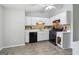Charming kitchen with white cabinets, black appliances, and ample countertop space at 1152 Sunday Ln, Jonesboro, GA 30238