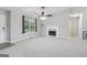 Inviting living room featuring neutral paint, plush carpet, fireplace, a ceiling fan, and plenty of natural light at 1152 Sunday Ln, Jonesboro, GA 30238