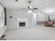 Bright living room with a white fireplace, ceiling fan, and view to dining area at 1152 Sunday Ln, Jonesboro, GA 30238