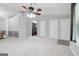 Open-concept living room with a ceiling fan, neutral walls, and entry to the laundry area at 1152 Sunday Ln, Jonesboro, GA 30238