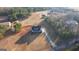 Stunning aerial view of a home with a long driveway, surrounded by mature trees and lush greenery in a quiet neighborhood at 4180 Mount Paran Dr, Social Circle, GA 30025