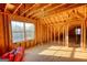 Spacious attic room with wooden framing, large windows, and natural light, ready for customization and expansion at 4180 Mount Paran Dr, Social Circle, GA 30025