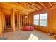 Bright attic space featuring wood framing, a large window, and potential for conversion to a bedroom or office at 4180 Mount Paran Dr, Social Circle, GA 30025