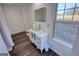 Bathroom with a modern vanity featuring a glass bowl sink, mirror and a view from the window at 4180 Mount Paran Dr, Social Circle, GA 30025