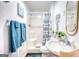 Bathroom with tub-shower combo, modern vanity and fixtures and blue decorative hand towels at 4180 Mount Paran Dr, Social Circle, GA 30025