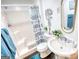 Bathroom with tub-shower combo, modern vanity and fixtures and blue decorative hand towels at 4180 Mount Paran Dr, Social Circle, GA 30025