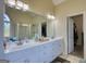 Bathroom featuring double sinks, ample vanity storage, and a large, well-lit mirror at 4180 Mount Paran Dr, Social Circle, GA 30025