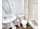Bright bathroom with a shower with curtain and a pedestal sink and medicine cabinet at 4180 Mount Paran Dr, Social Circle, GA 30025