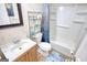 Bathroom with white tub-shower combo, modern vanity and fixtures and blue patterned shower curtain at 4180 Mount Paran Dr, Social Circle, GA 30025