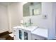Close-up of bathroom vanity featuring a modern glass bowl sink and cabinet storage at 4180 Mount Paran Dr, Social Circle, GA 30025