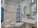 Bright bathroom featuring a shower with patterned curtain and an elegant pedestal sink at 4180 Mount Paran Dr, Social Circle, GA 30025