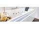 Luxurious bathtub features jacuzzi jets and sleek design with decorative accents nearby at 4180 Mount Paran Dr, Social Circle, GA 30025