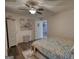 Bedroom with a ceiling fan, doorway, and decorative flower art on the wall at 4180 Mount Paran Dr, Social Circle, GA 30025