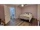 Bedroom showcases modern flooring, a queen-size bed, and convenient access to an ensuite bathroom at 4180 Mount Paran Dr, Social Circle, GA 30025