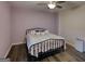 A cozy bedroom featuring a ceiling fan, ample space and modern flooring at 4180 Mount Paran Dr, Social Circle, GA 30025