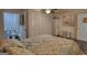 Comfortable bedroom with a ceiling fan, connected bathroom, and decorative flower art at 4180 Mount Paran Dr, Social Circle, GA 30025