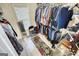 Walk-in closet with ample hanging space, shelving, mirror, and natural light at 4180 Mount Paran Dr, Social Circle, GA 30025