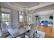 Dining room with hardwood floors, modern chandelier, chair-rail, and natural light at 4180 Mount Paran Dr, Social Circle, GA 30025