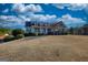 Inviting two-story home featuring a large front yard and a charming covered porch, perfect for relaxing outdoors at 4180 Mount Paran Dr, Social Circle, GA 30025