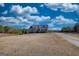 Beautiful home showcasing a well-maintained lawn and a long driveway leading to the residence under a cloudy blue sky at 4180 Mount Paran Dr, Social Circle, GA 30025