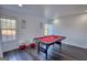 Bright game room features a pool table and two cushioned ottomans under natural light from two windows at 4180 Mount Paran Dr, Social Circle, GA 30025