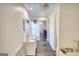 Hallway showcasing a vanity on the left and a game room with a pool table at the end at 4180 Mount Paran Dr, Social Circle, GA 30025
