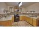 Well-equipped kitchen features wood cabinets, modern appliances, and tiled backsplash, perfect for culinary adventures at 4180 Mount Paran Dr, Social Circle, GA 30025