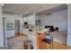 Kitchen featuring stainless appliances, wooden bar and view into the living room at 4180 Mount Paran Dr, Social Circle, GA 30025