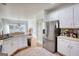 Well-lit kitchen featuring stainless steel appliances, and white cabinets at 4180 Mount Paran Dr, Social Circle, GA 30025