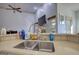 The kitchen features a sink with stone countertop and a view of the home's outdoor living space at 4180 Mount Paran Dr, Social Circle, GA 30025