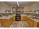 A cozy kitchen features wood cabinets, updated appliances, mosaic backsplash and wood-look floors at 4180 Mount Paran Dr, Social Circle, GA 30025
