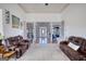 Open floor plan with living room leading to dining and entry way; features leather seating at 4180 Mount Paran Dr, Social Circle, GA 30025