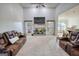 Bright living room with high ceilings, fireplace, and cozy leather furniture at 4180 Mount Paran Dr, Social Circle, GA 30025