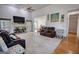 Open-concept living room with fireplace, plush carpeting, and comfortable seating arrangement at 4180 Mount Paran Dr, Social Circle, GA 30025
