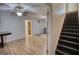 Inviting living room with wood floors, ceiling fans, and staircase, perfect for gatherings and everyday living at 4180 Mount Paran Dr, Social Circle, GA 30025